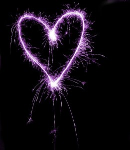 a magenta coloured sparkling love heart valentine theme image on a black background